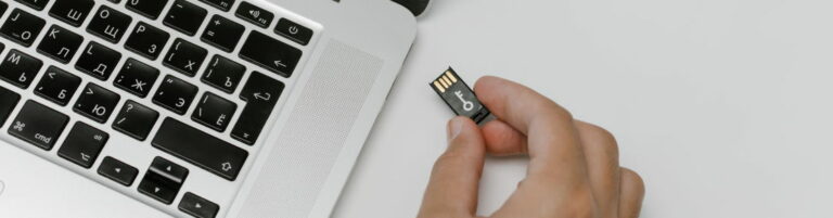 Holding USB key going into laptop