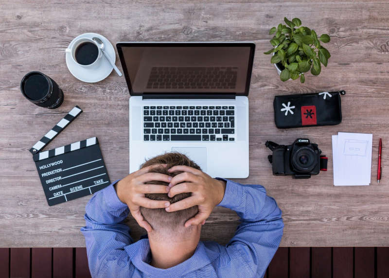 Man in front of laptop frustrated